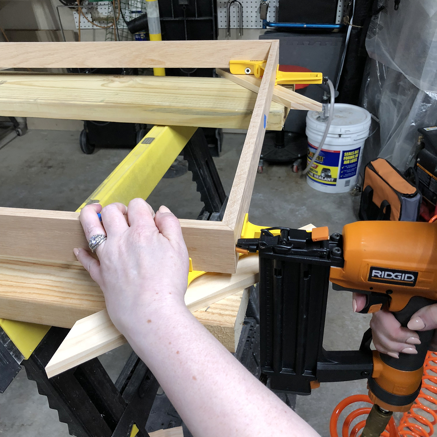 Using a nail gun to secure frame corners