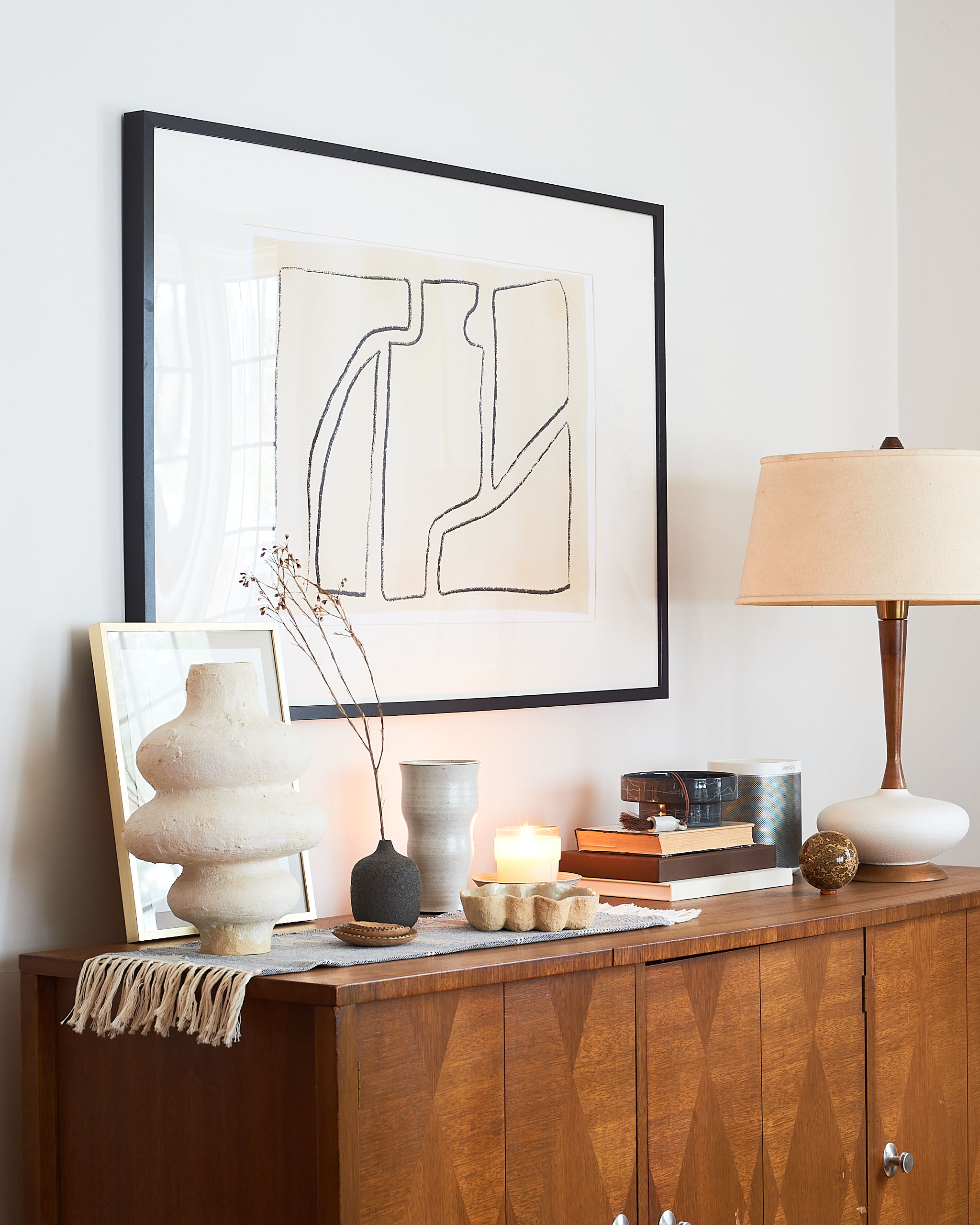 Ceramic vessels styled on a credenza