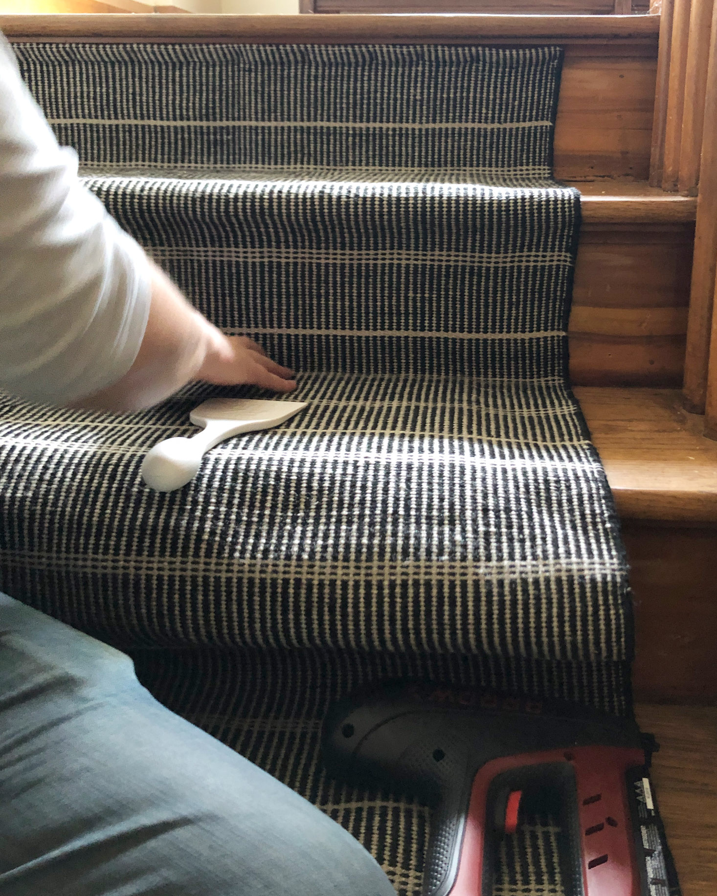 Using the carpet tucker tool on the stair runner