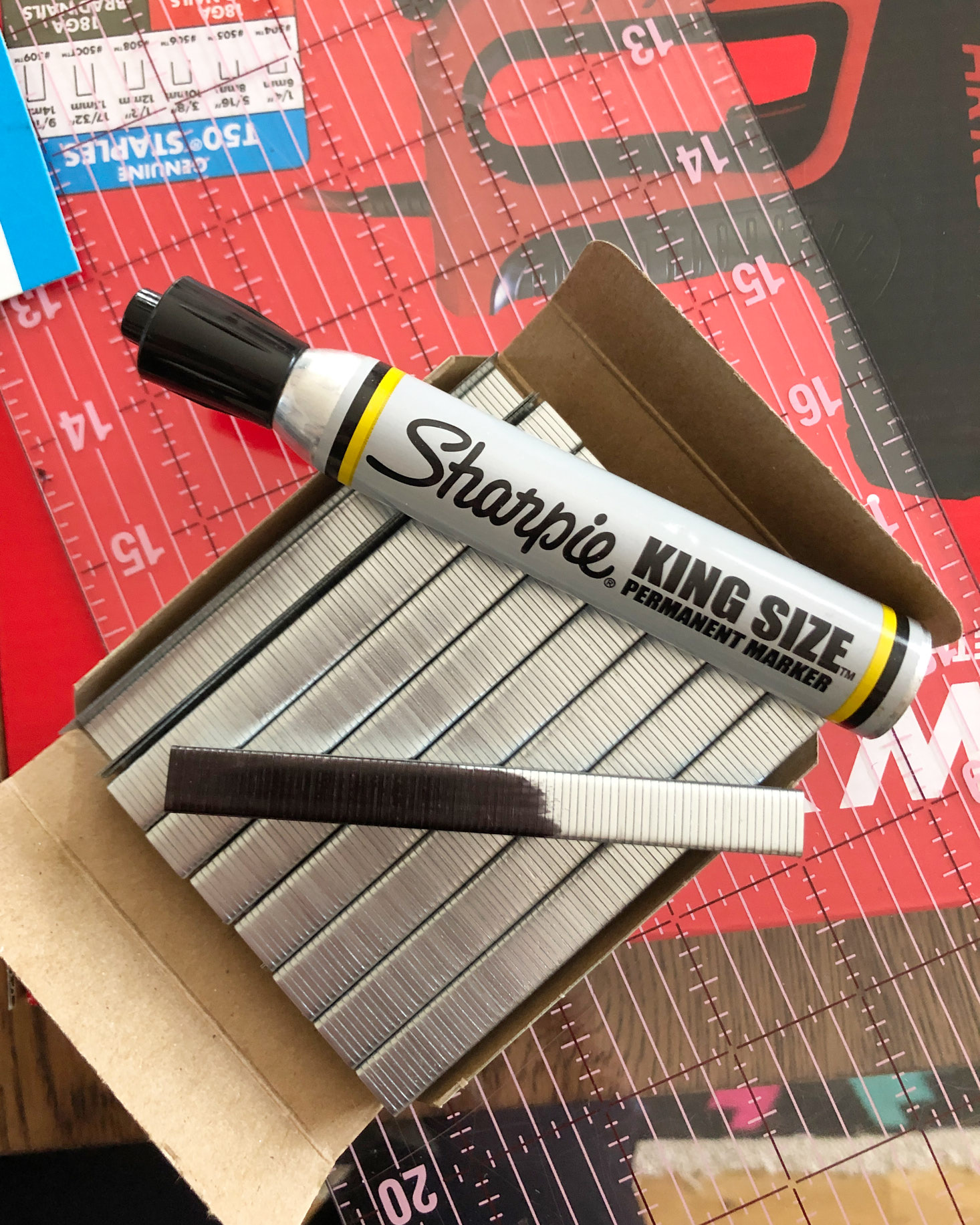 Blacken staples with sharpie